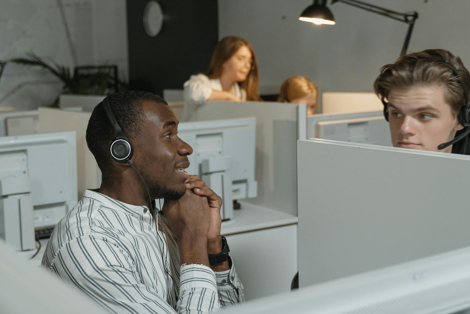 Call center team collaborating with headsets, providing efficient customer support.