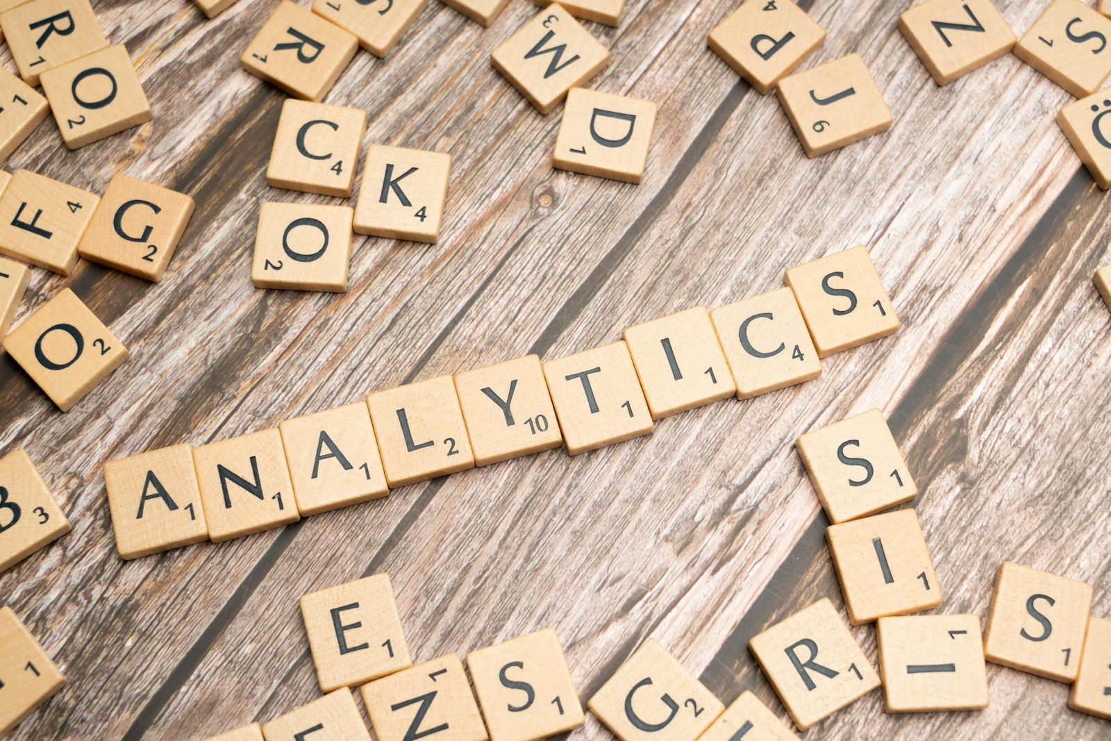Scrabble tiles spelling Analytics on a wooden surface