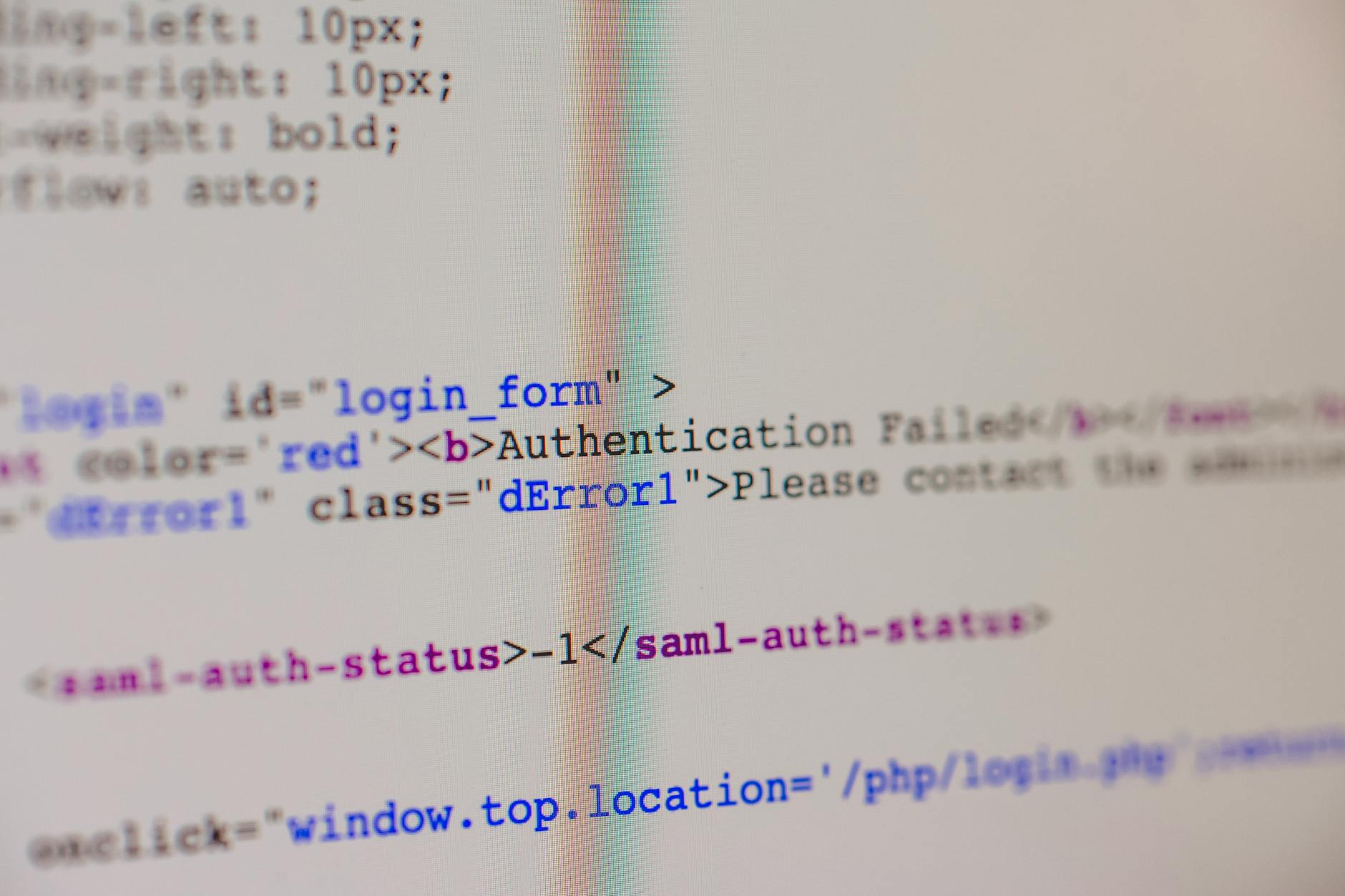 Close-up of HTML and PHP code on screen showing error message and login form data.