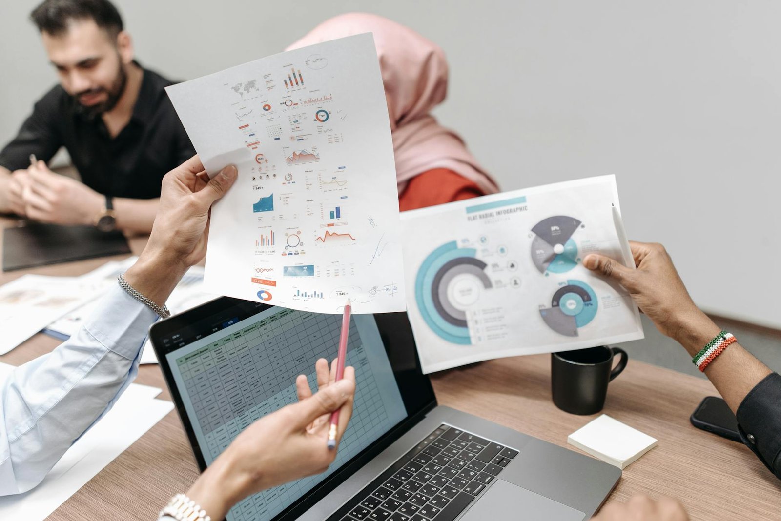 Team reviewing and organizing data records in an office setting